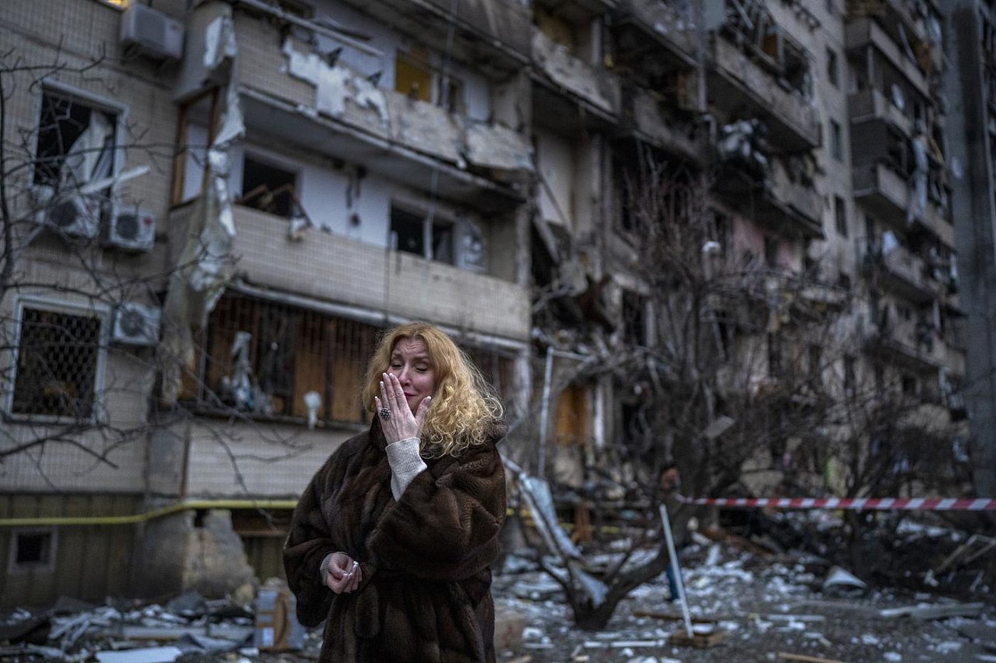 Kyiv resident Natalia Sevriukova reacts next to her house following a rocket attack on Kyiv, Ukraine. February 25, 2022Emilio Morenatti - AP Photo